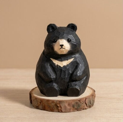 Wooden bear figurine on a natural wood base against a beige background