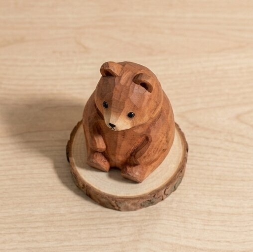 Wooden bear figurine on a wooden base