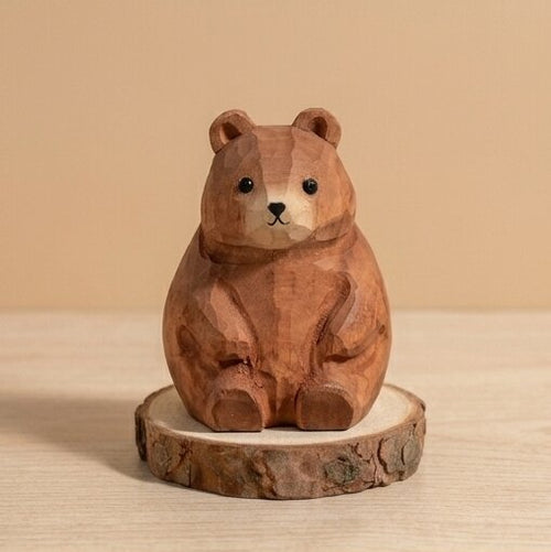 Wooden bear figurine on a wooden base against a beige background