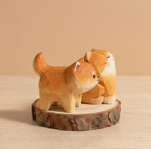 Angled view hand carved wooden pet toy figurine design, geometric faceted natural wood finish, Montessori educational toy for toddlers developmental play and small world activities