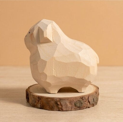 Angled view hand carved wooden animal toy rabbit sheep design, geometric faceted natural wood finish, Montessori educational toy for toddlers developmental play and storytelling