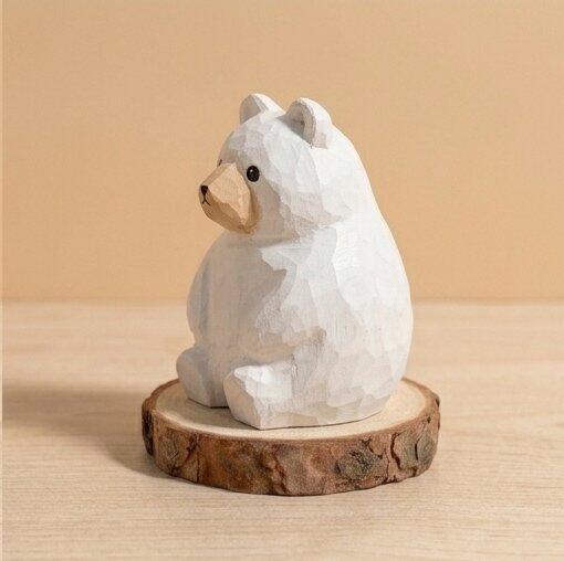 White bear figurine on a wooden base against a beige background