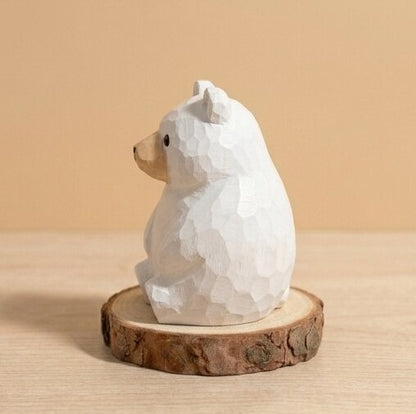 White bear figurine on a wooden base against a beige background