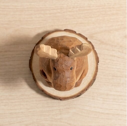 Wooden deer figure on a wooden circular base