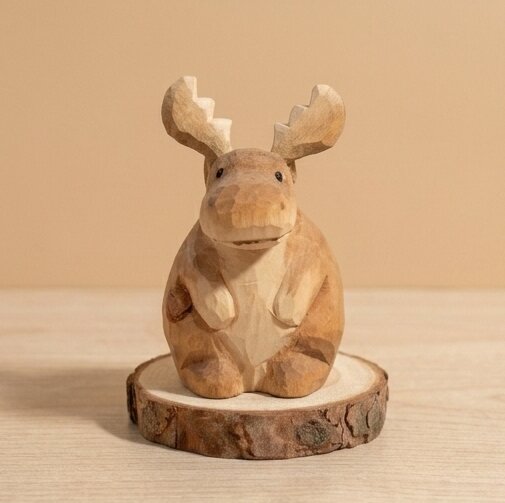 Side profile view handcrafted wooden moose animal figurine showing carved antlers details, sustainable natural wood toy safe for kids 18 months+, eco-friendly forest animal toy for toddler playroom and storytelling