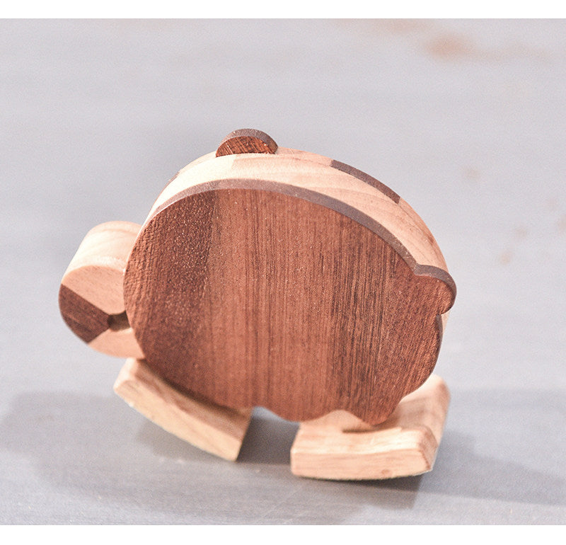 Back view of a handcrafted wooden tiger ramp walker toy showing natural wood grain and contrasting hardwood details.