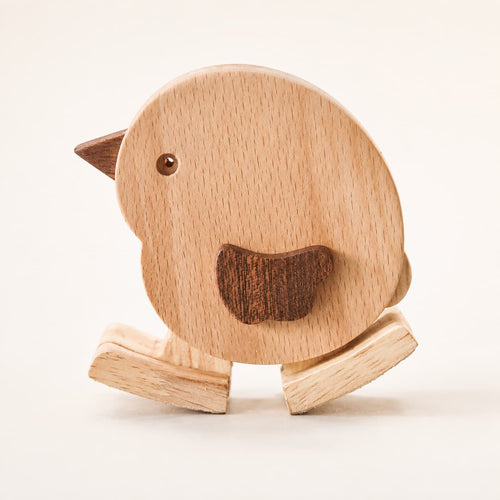 Close-up of a handmade wooden chicken ramp walker with natural wood grain and walking feet