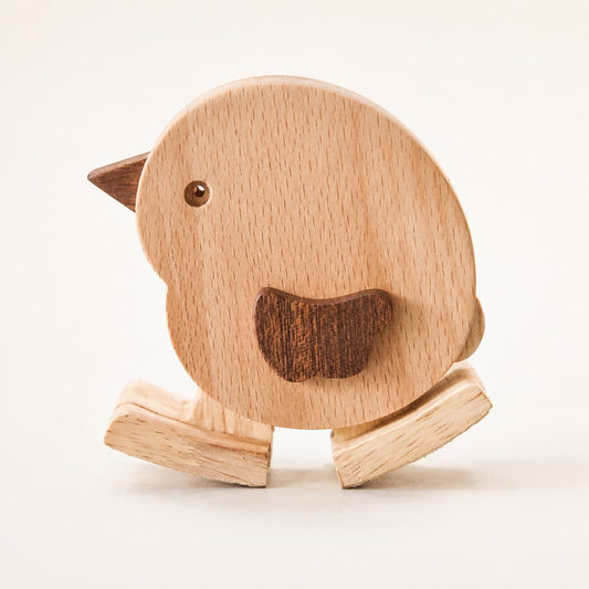 Close-up of a handmade wooden chicken ramp walker with natural wood grain and walking feet