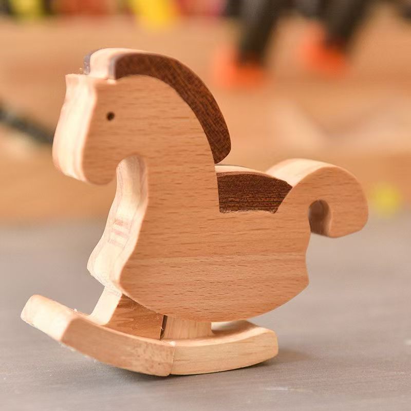 Montessori-inspired mechanical gravity horse toy on a wooden ramp, perfect for toddler open-ended play and early physics learning.