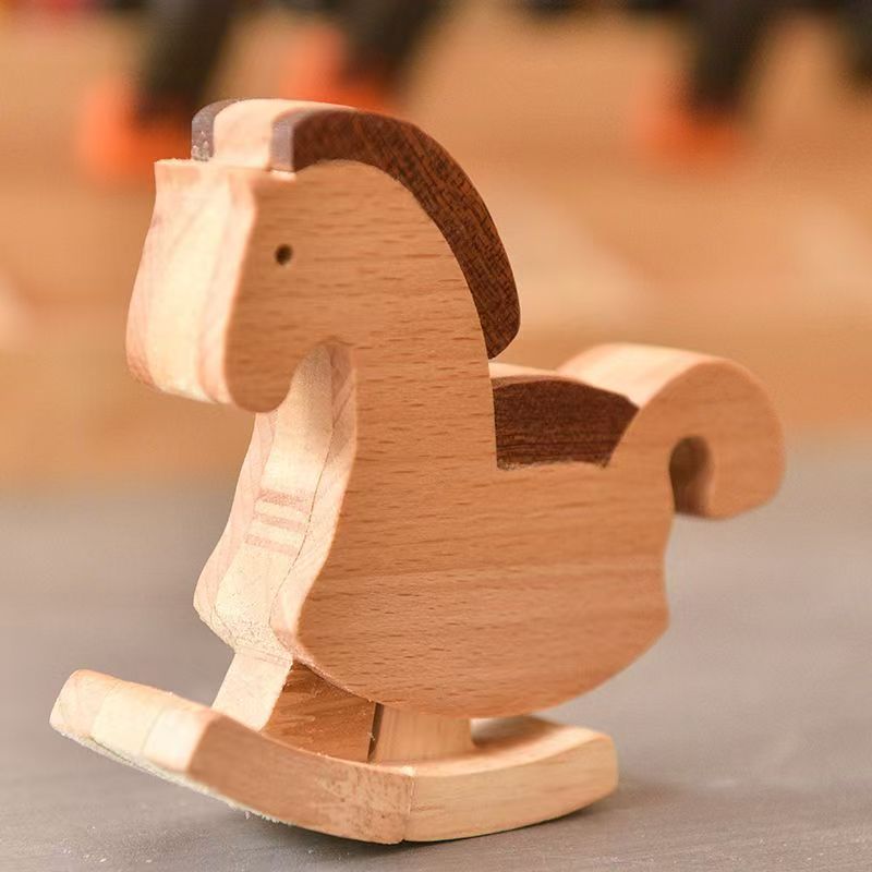 Side view of a vintage-style mechanical gravity walking horse toy balancing and stepping down a precision-engineered wooden ramp track.