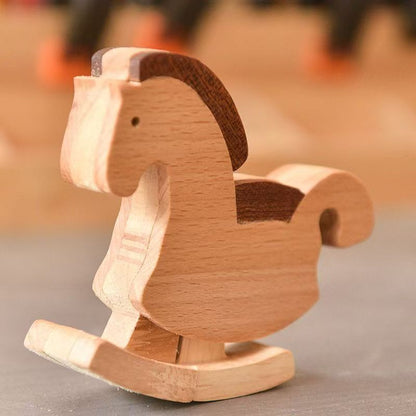 Side view of a vintage-style mechanical gravity walking horse toy balancing and stepping down a precision-engineered wooden ramp track.
