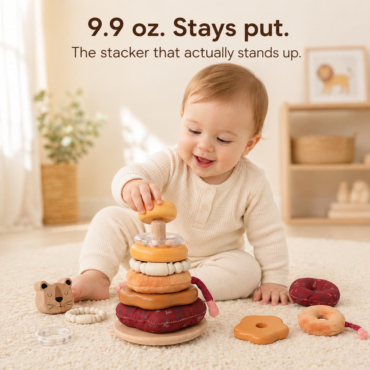 10 month old baby stacking Lion Wooden Stacker on wooden floor, 9.9 oz solid beech wood stays put