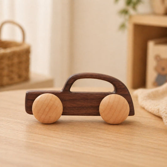 A handcrafted Montessori-inspired wooden toy car made from dark walnut and light maple wood, featuring a minimalist ergonomic design for toddler grasping and push-along play.