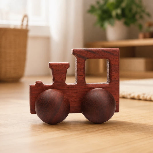 Handcrafted minimalist walnut wooden train toy on a light-colored wood floor, designed for Montessori-inspired play and fine motor skill development.