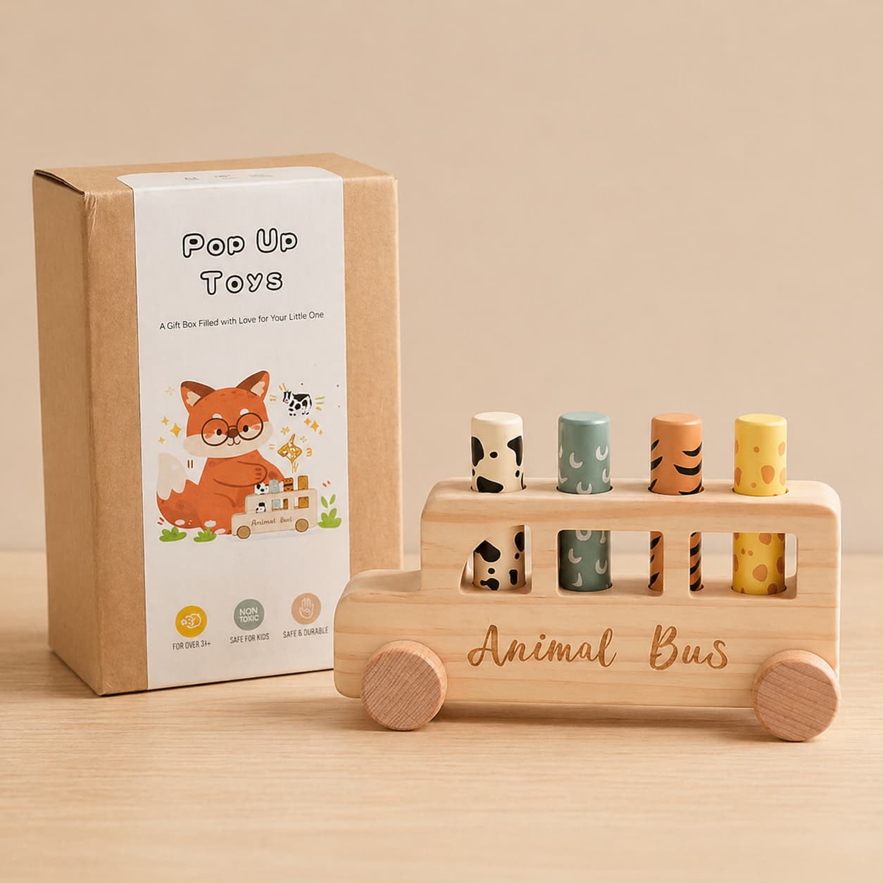 A Montessori wooden animal bus pop-up toy with its gift packaging, featuring four colorful animal-patterned pegs designed to develop toddler fine motor skills and cause-and-effect understanding.