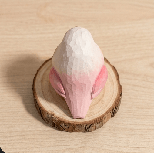 Top view pink and white wooden bird toy showing geometric wing details, handcrafted lovebird figurine natural wood base sustainable children toy for nursery decor