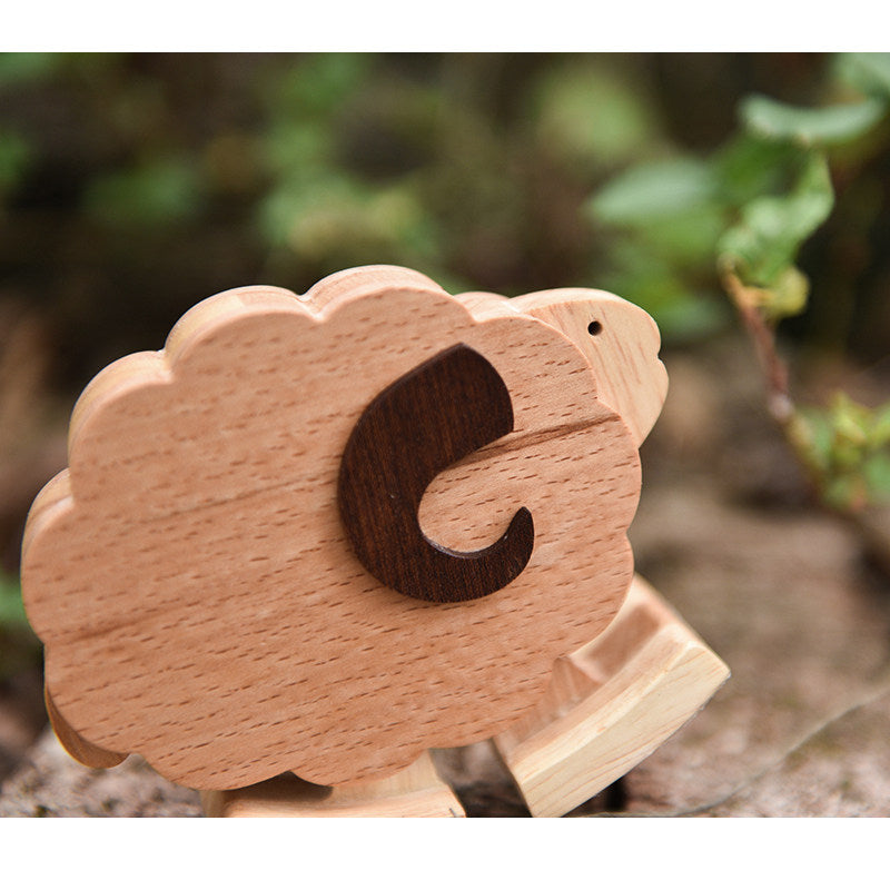 Artisan made wooden sheep walking animal using kinetic energy and gravity.
