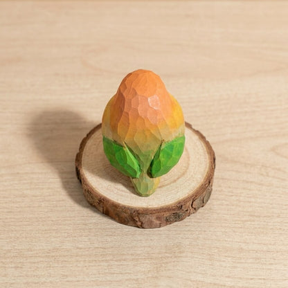 Back view wooden bird toy showing handpainted green wings, geometric lovebird figurine natural wood craft, sustainable wooden animal toy for children