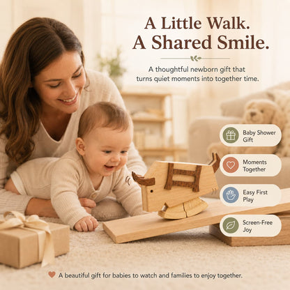 A mother and her baby looking at a large wooden bull ramp walker toy on a slope, highlighting it as a thoughtful baby shower gift for quality family moments.
