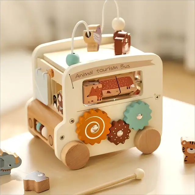 Wooden toy bus with animal figures and educational elements on a light surface.