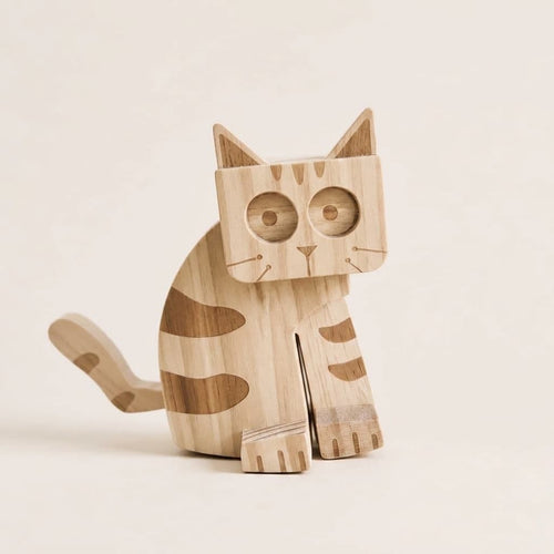 A wooden cat ramp walking toy with a natural light wood finish and darker brown grain patterns, shown against a solid, warm off-white background.