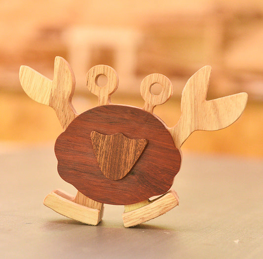 Wooden crab toy with a brown center on a blurred background