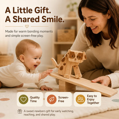 A mother smiling at her baby boy during floor play as a wooden dog ramp walker toy glides down a small wooden incline, showing a screen-free bonding moment.