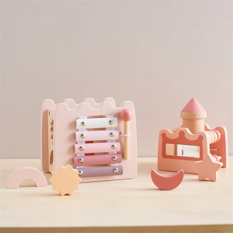 Set of pastel-colored wooden toys on a light surface with a neutral background