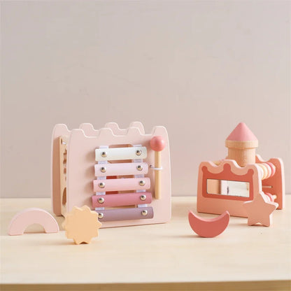 Set of pastel-colored wooden toys on a light surface with a neutral background