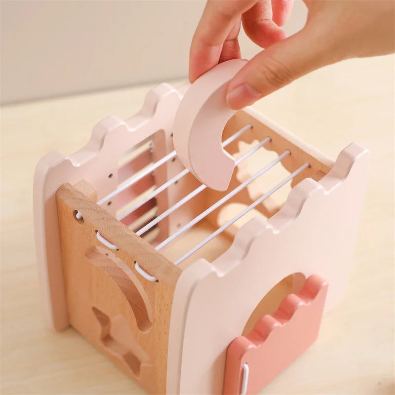 Wooden and pink kitchen rack with a hand placing an item on it