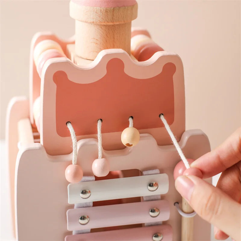 Close-up of a pink wooden toy with a hand interacting with it