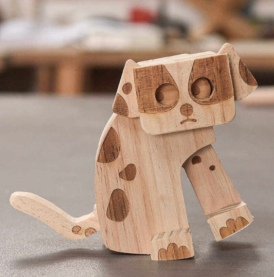 Wooden dog figurine on a gray surface with a blurred background
