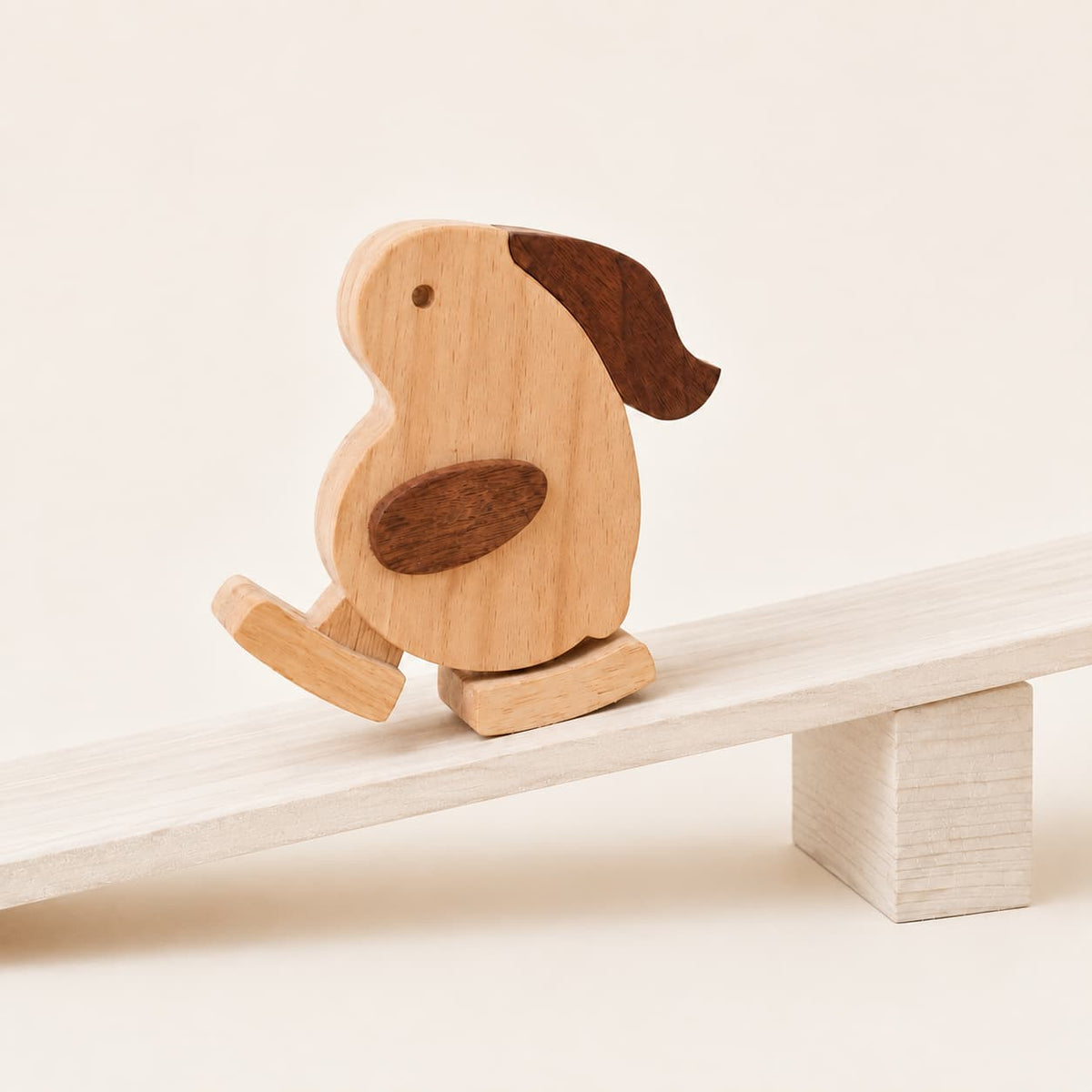 Wooden rabbit ramp walker toy stepping down a white wooden ramp using gravity.