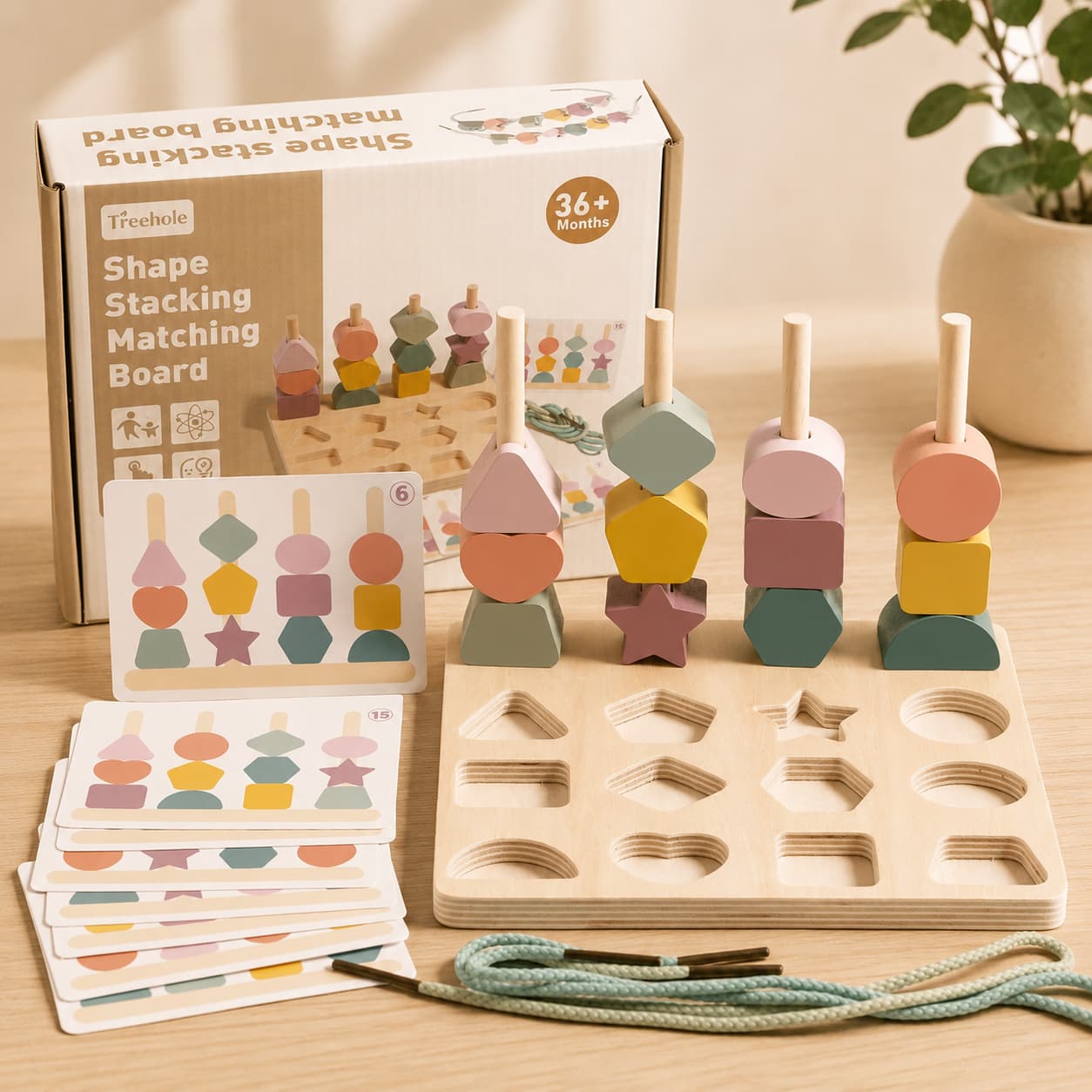 Wooden shape stacking matching board with cards and packaging on a wooden surface.