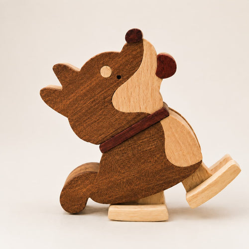 Close-up of a handmade wooden Shiba Inu ramp walker toy with walnut and beech wood details.