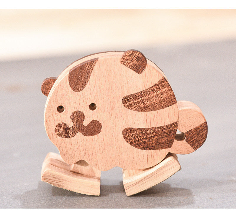 Handcrafted wooden tiger ramp walker toy with striped hardwood details and smooth rounded edges for screen-free toddler play.