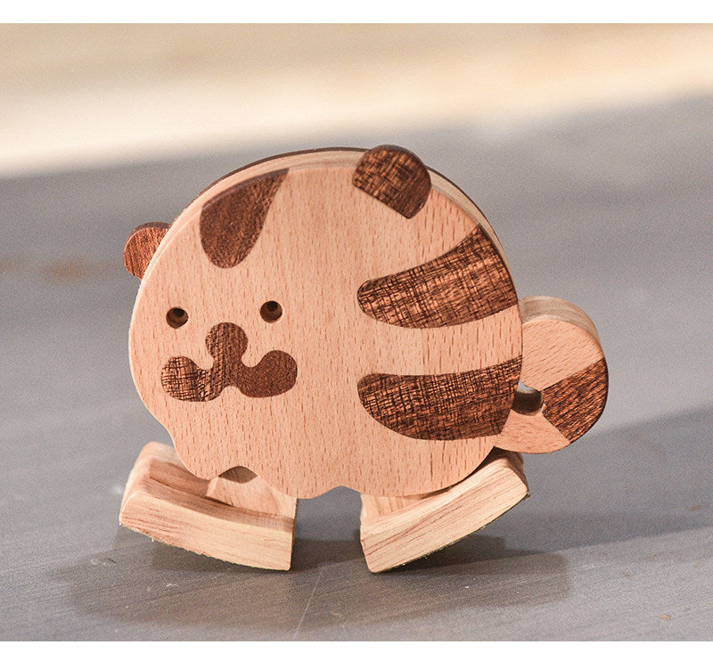 Close-up of a wooden tiger ramp walker toy with striped details, natural wood grain, and rounded edges.