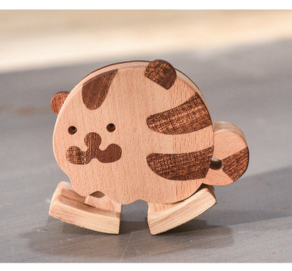 Close-up of a wooden tiger ramp walker toy with striped details, natural wood grain, and rounded edges.