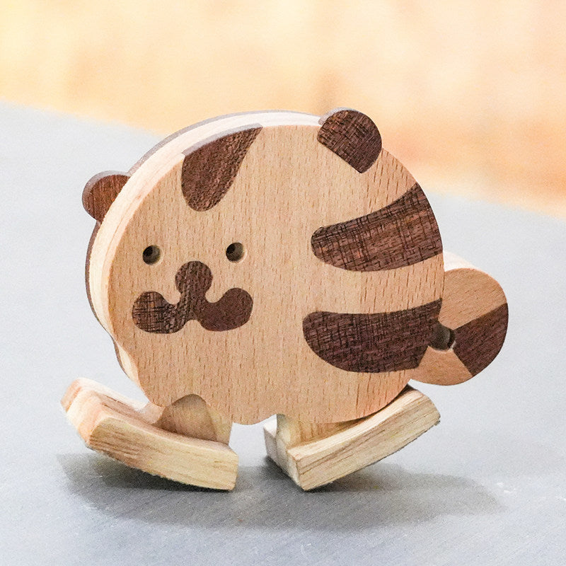 Wooden tiger ramp walker toy made from natural hardwoods for screen-free toddler play and gravity-powered movement.