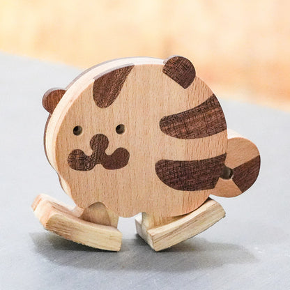 Wooden tiger ramp walker toy made from natural hardwoods for screen-free toddler play and gravity-powered movement.