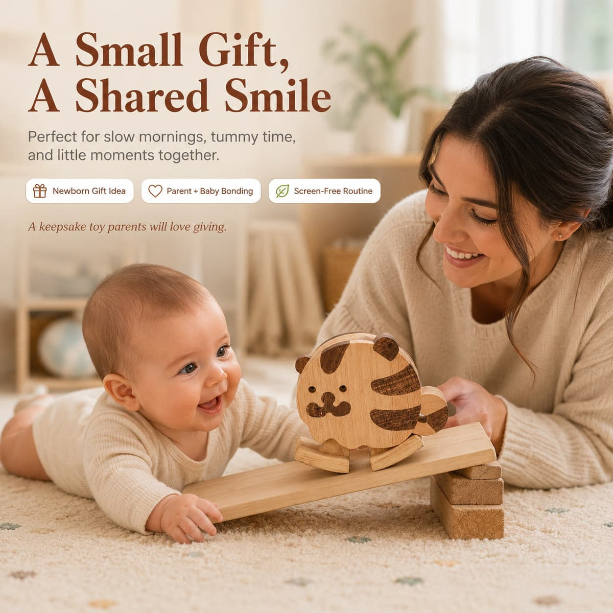 A mother watching her happy baby during tummy time as a wooden tiger ramp walker toy slides down a small ramp, showing natural parent-child bonding.