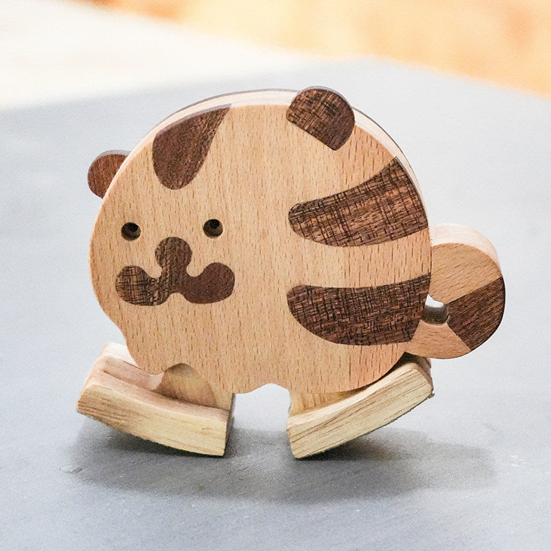 Wooden tiger ramp walker toy with striped wood details for screen-free toddler play.