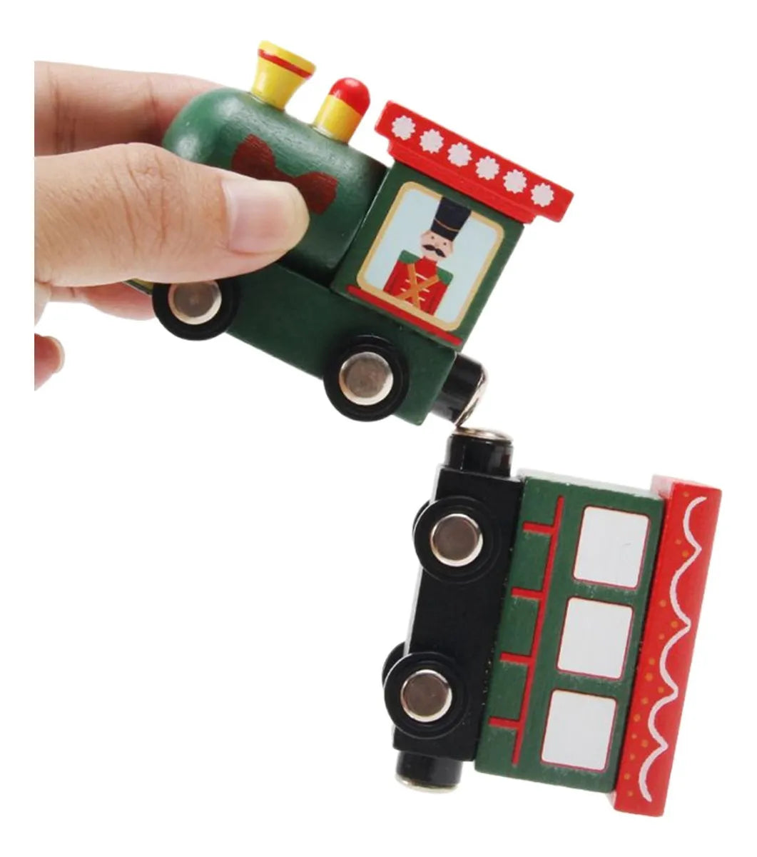 Toy train model held by a hand on a white background